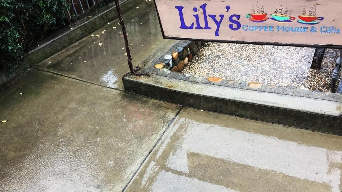 Rain falls Wednesday morning outside Lily’s on Main Street in Cambria’s East Village.