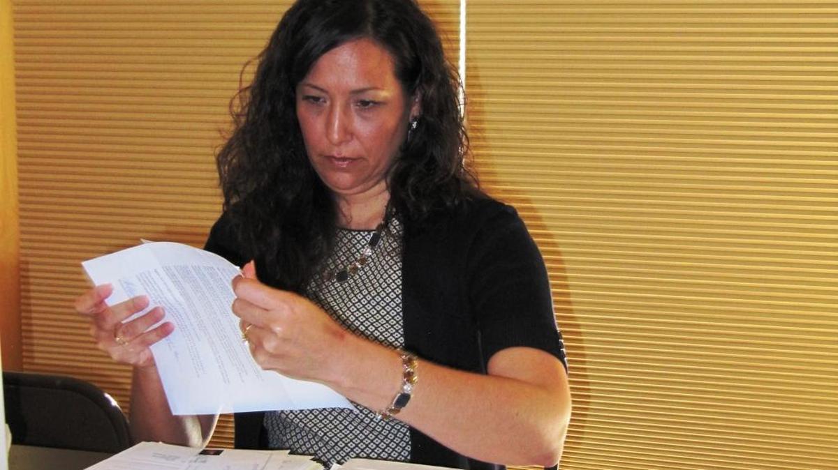 Elaina Cano, deputy county clerk recorder, validates rate-increase protests at the Feb. 12 meeting.