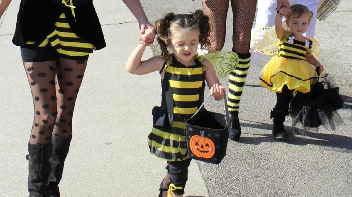 A family of “bees” walks down Main Street during last year’s West Village parade.