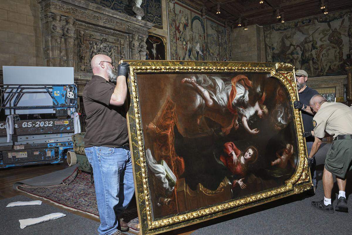 New Hearst Castle curator Toby Selyem, retired Castle curator Frank Young and Steve Brough handle a circa-1690 painting of the Annunciation by Spanish artist Bartolomé Pérez de la Dehesa. The men removed the painting from the wall in 2017 for photography and verification of a recently discovered monogram and inscription, then rehung it in the Assembly Room of the estate’s main house, La Casa Grande.