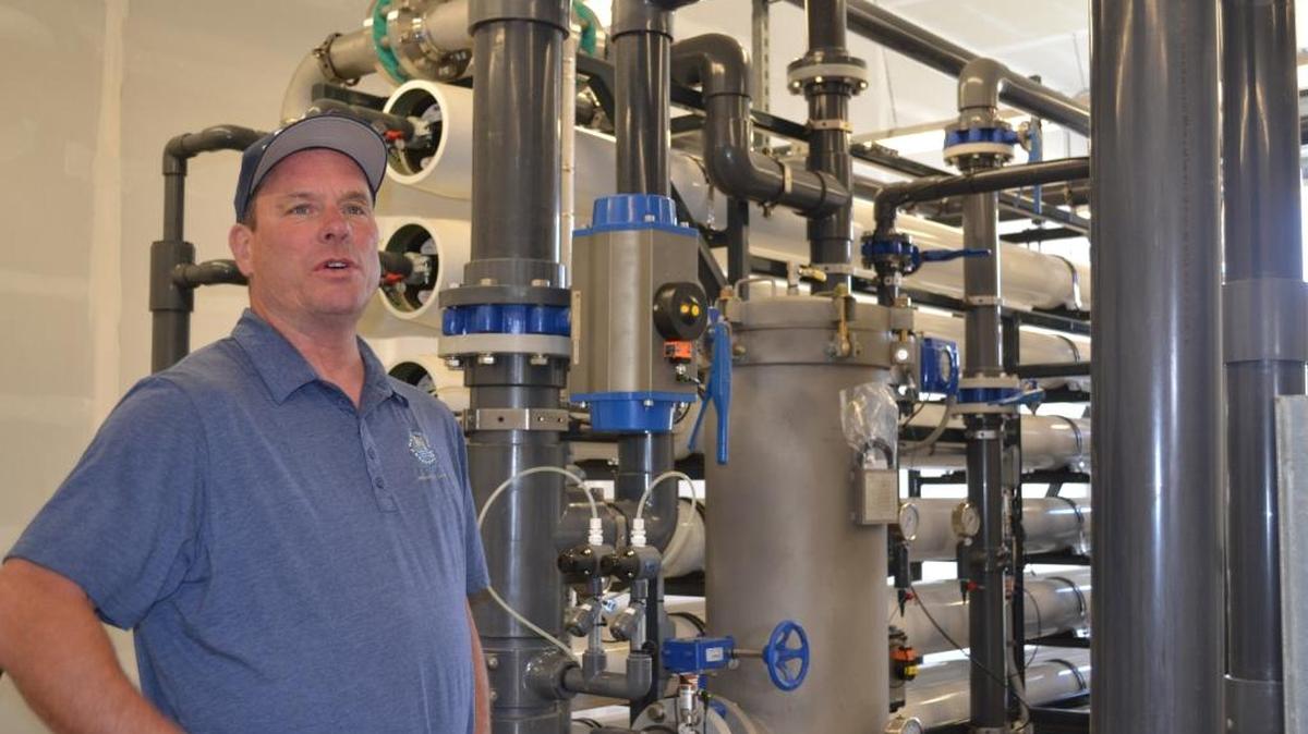 Jerry Copeland shows off the San Simeon reverse-osmosis unit.