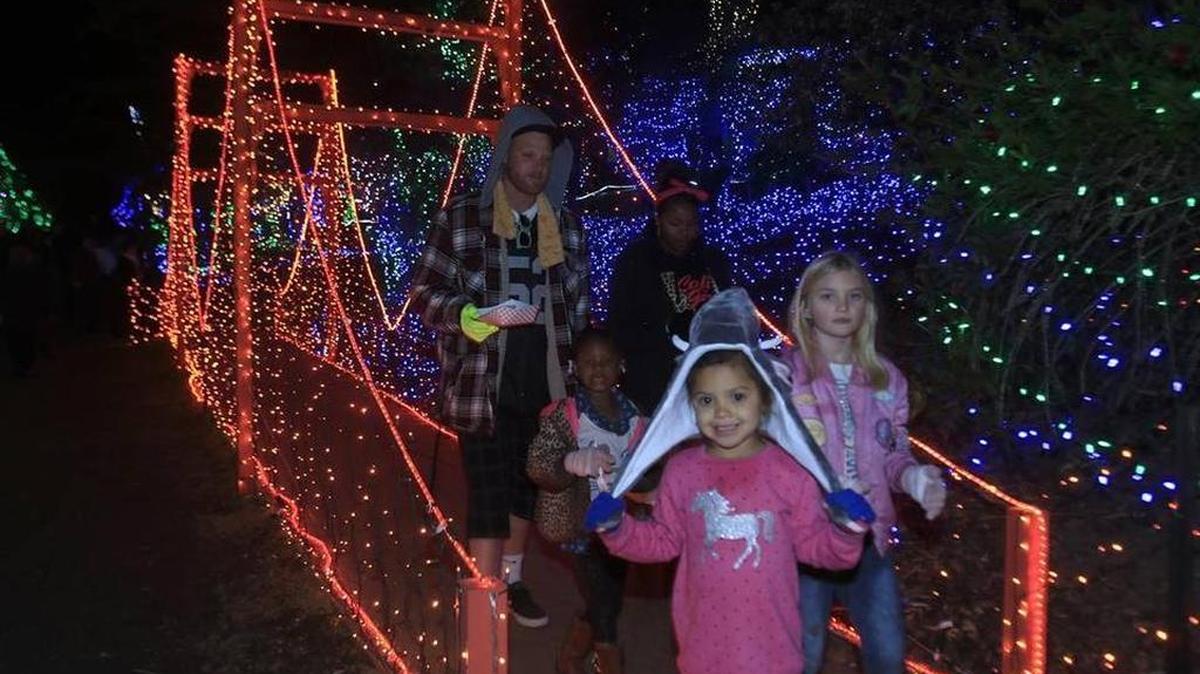 A family takes a walk on the Golden Gate Bridge light display at the Cambria Christmas Market. Kasha Daniloff, 5, leads the way; behind her on left is Janessa Harris, 5, and behind Kasha on right is Kyla King, 7. Derek King is at rear left, and Jasmine Holt, rear right.