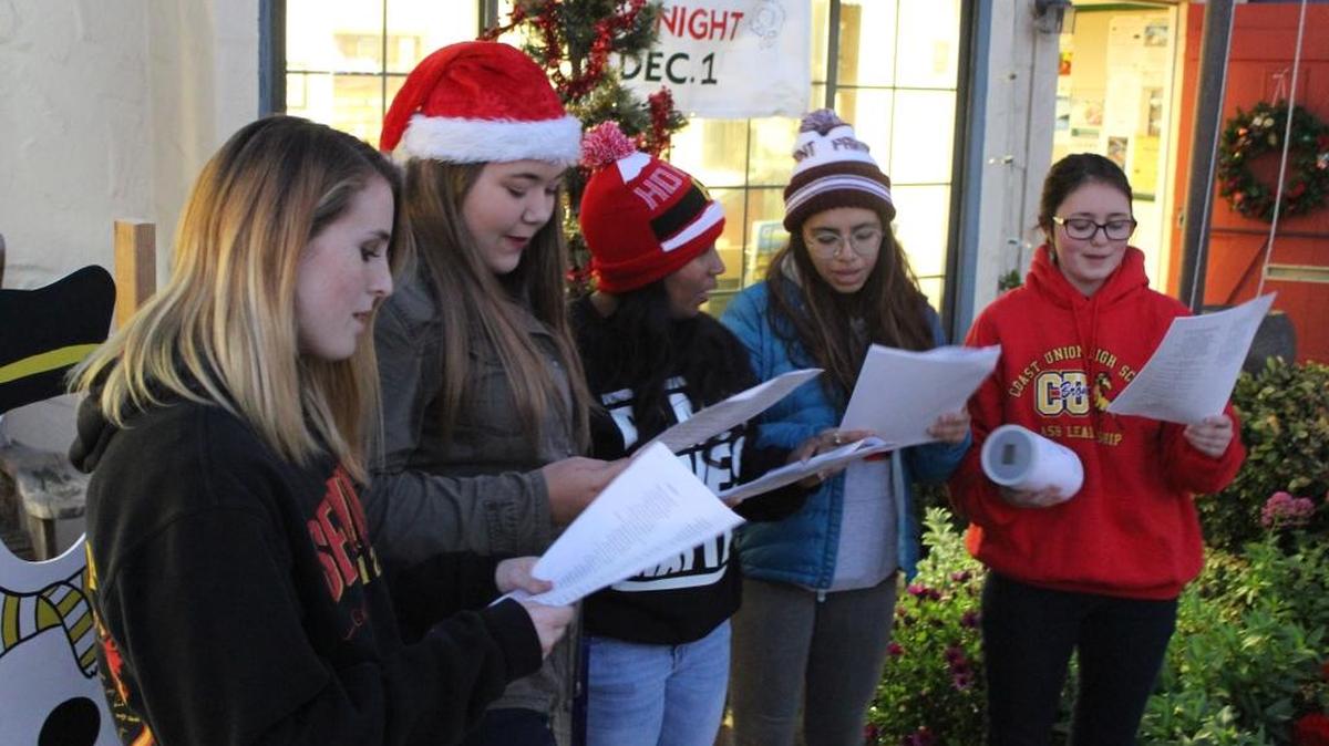 From left, Coast Union students Holly McHaffie, Abby Spradley, Lindy Ortiz, Michelle Campos and Isabella Hargear sing Christmas carols in front of the Cambria Chamber of Commerce on Hospitality Night, Thursday, Dec. 1.