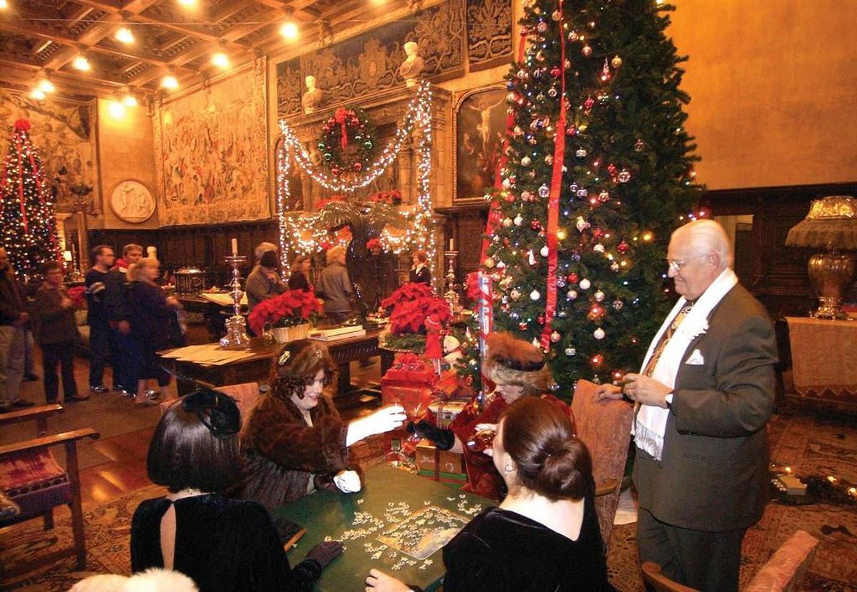 Docents work on a puzzle at Hearst Castle during the Christmas season in 2005. Seated clockwise from lower left, Kristi Yegge, Kristin Cheadle, Lynda Snodgrass, and Sylvia Huth. Standing is Bob Huth.