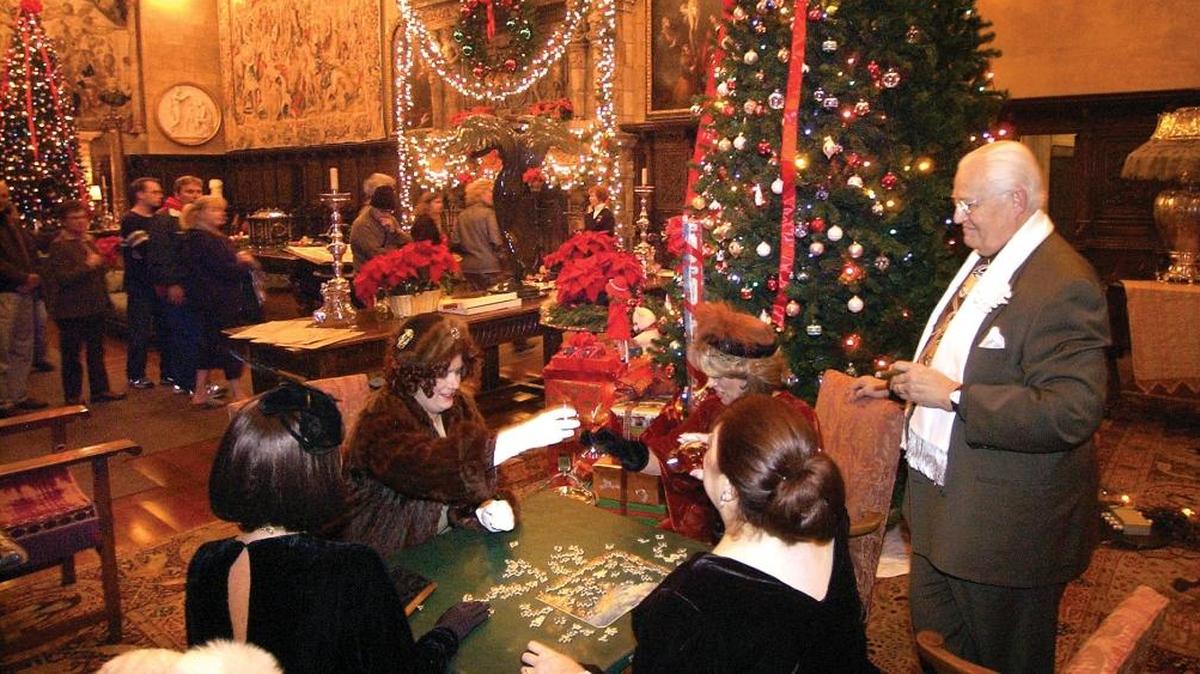 Docents work on a puzzle at Hearst Castle during the Christmas season in 2005. Seated clockwise from lower left, Kristi Yegge, Kristin Cheadle, Lynda Snodgrass, and Sylvia Huth. Standing is Bob Huth.