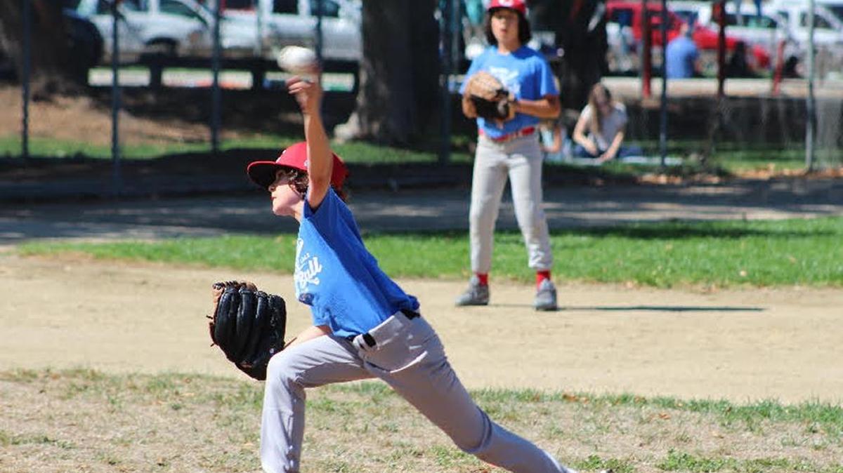 Reds’ lefty Robert Saunders joined with three other pitchers in holding Atascadero to just one run in a 12-1 victory Sunday, Oct. 2. Third baseman Alan Nunez is in the background.