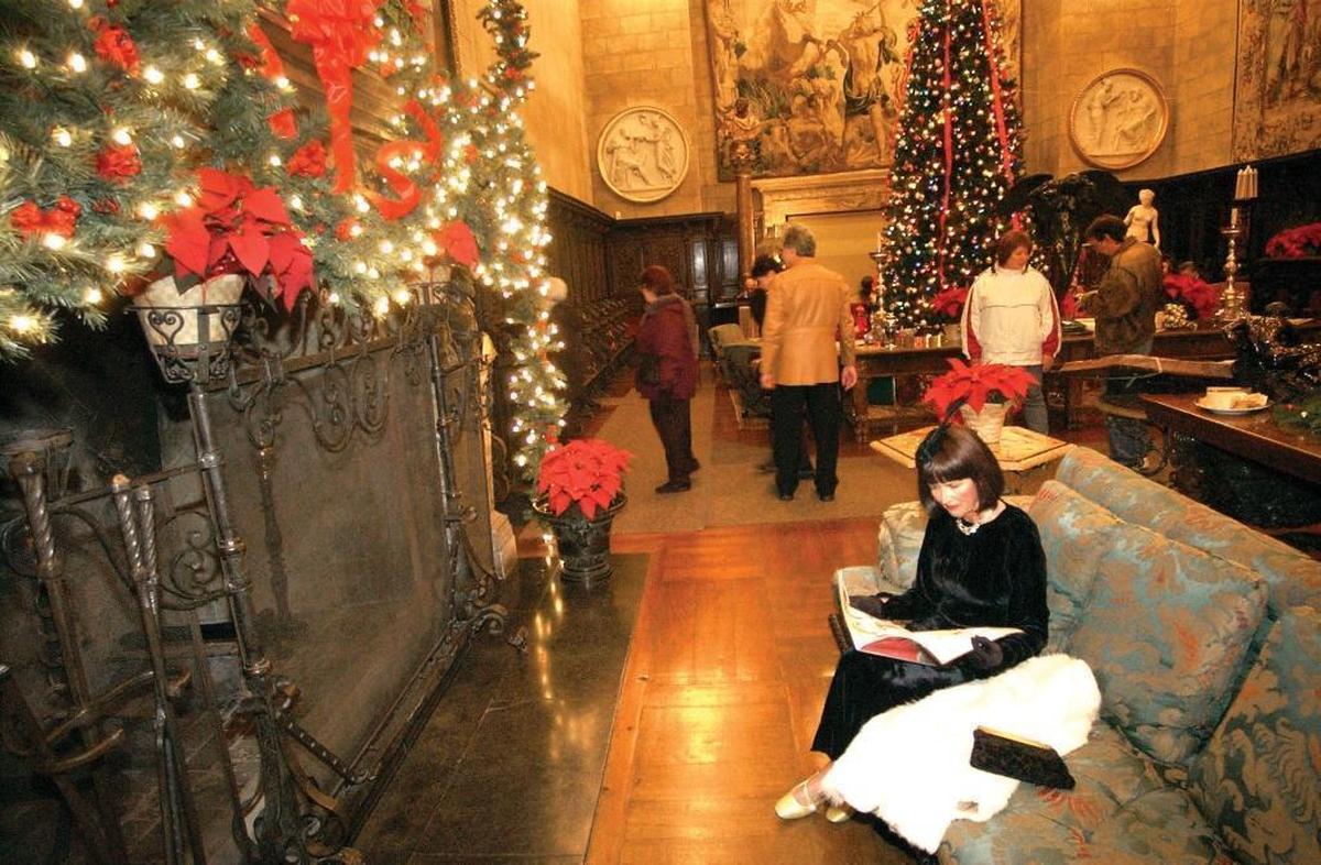 Kristi Yegge reads a magazine in the Hearst Castle assembly room during the Christmas season, 2005. Dan Falat said participation in tours held the week prior to and after Christmas was 36,234 in 2017, compared with 44,793 the previous year.