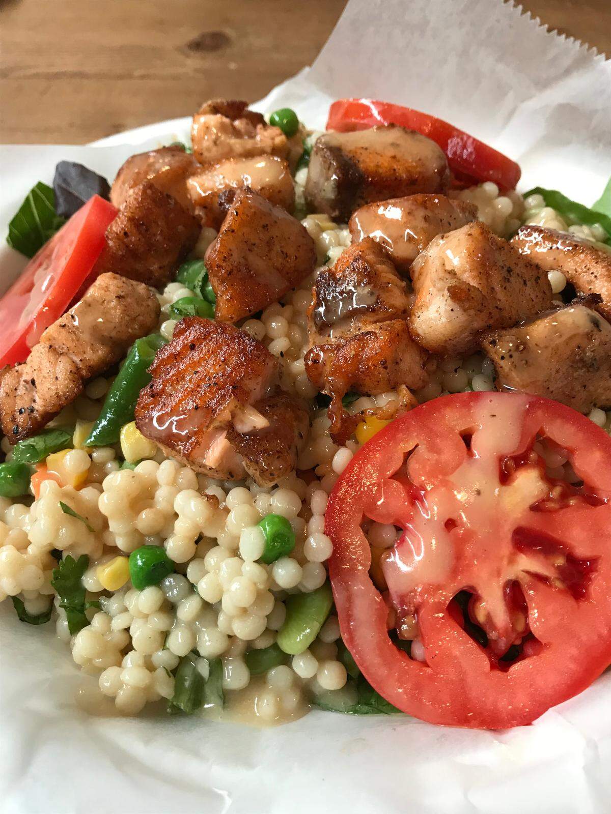 A salmon salad at Hearst Ranch Winery in San Simeon features chunks of salmon atop lemon vinaigrette-scented couscous and vegetables.