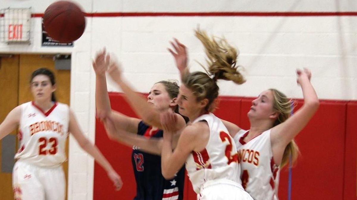 Lady Broncos Karis Lawson (left) and Ellie Kennedy — with Kaylee Ferguson (23) in the background — battle for the ball on every play in every game. Here the girls scramble for possession in a game earlier this month.