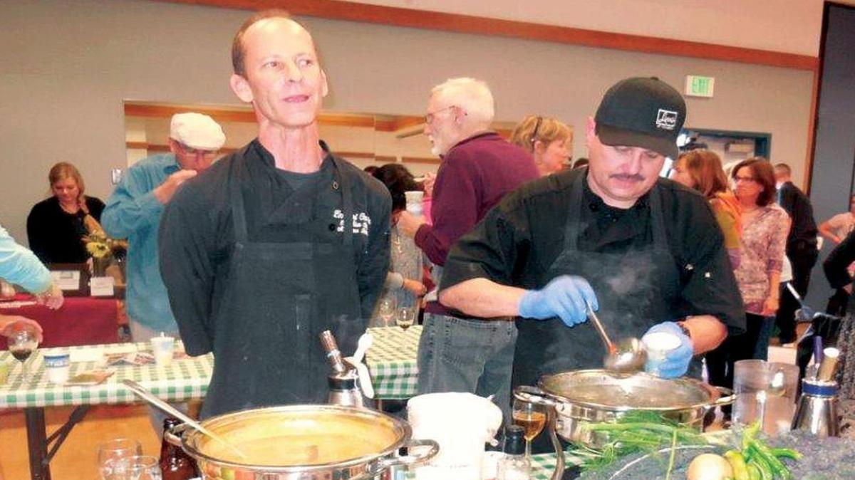 Chef Matt Beckett of Linn’s describes the ingredients in his award-winning soups, as Chef Richard Lawson ladles out a sample, at the Soupabration! event in 2014.