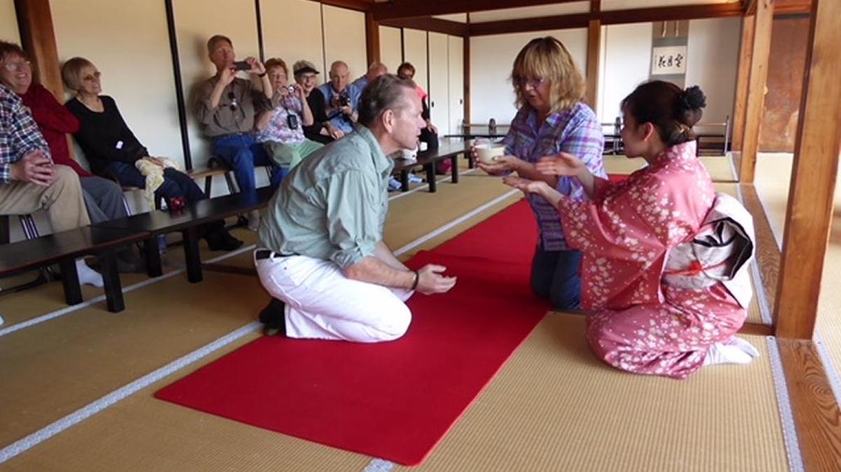John O’Regan, owner of San Simeon Travel, and Elaine Beckham of Cambria, center, perform a tea ceremony in Japan, where O’Regan led a group tour.