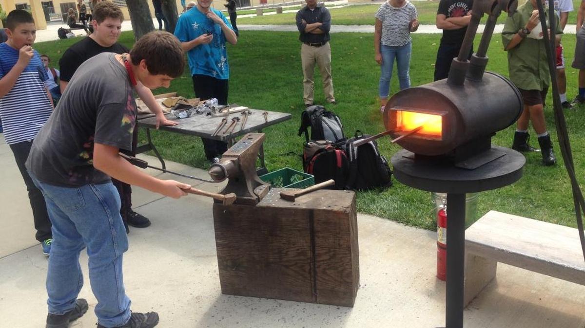 Blacksmithing Club President Nick Robinson offers a demonstration in the Coast Union High School Quad.