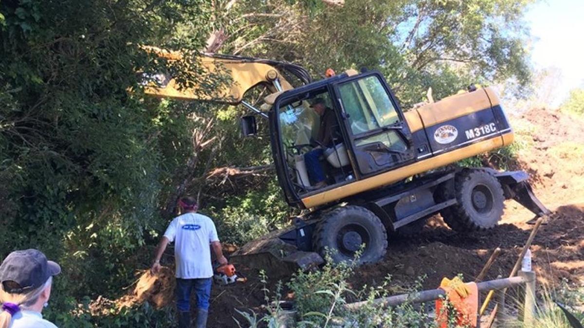 Workers use heavy equipment to get at the leak behind the Bluebird Inn on Monday, June 26, in Cambria.