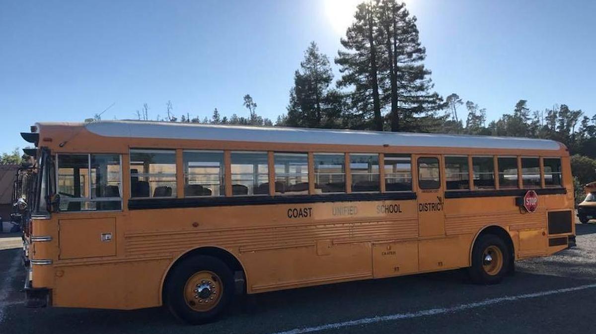 A school bus is parked at the Coast Unified Transportation Department behind Coast Union High School.