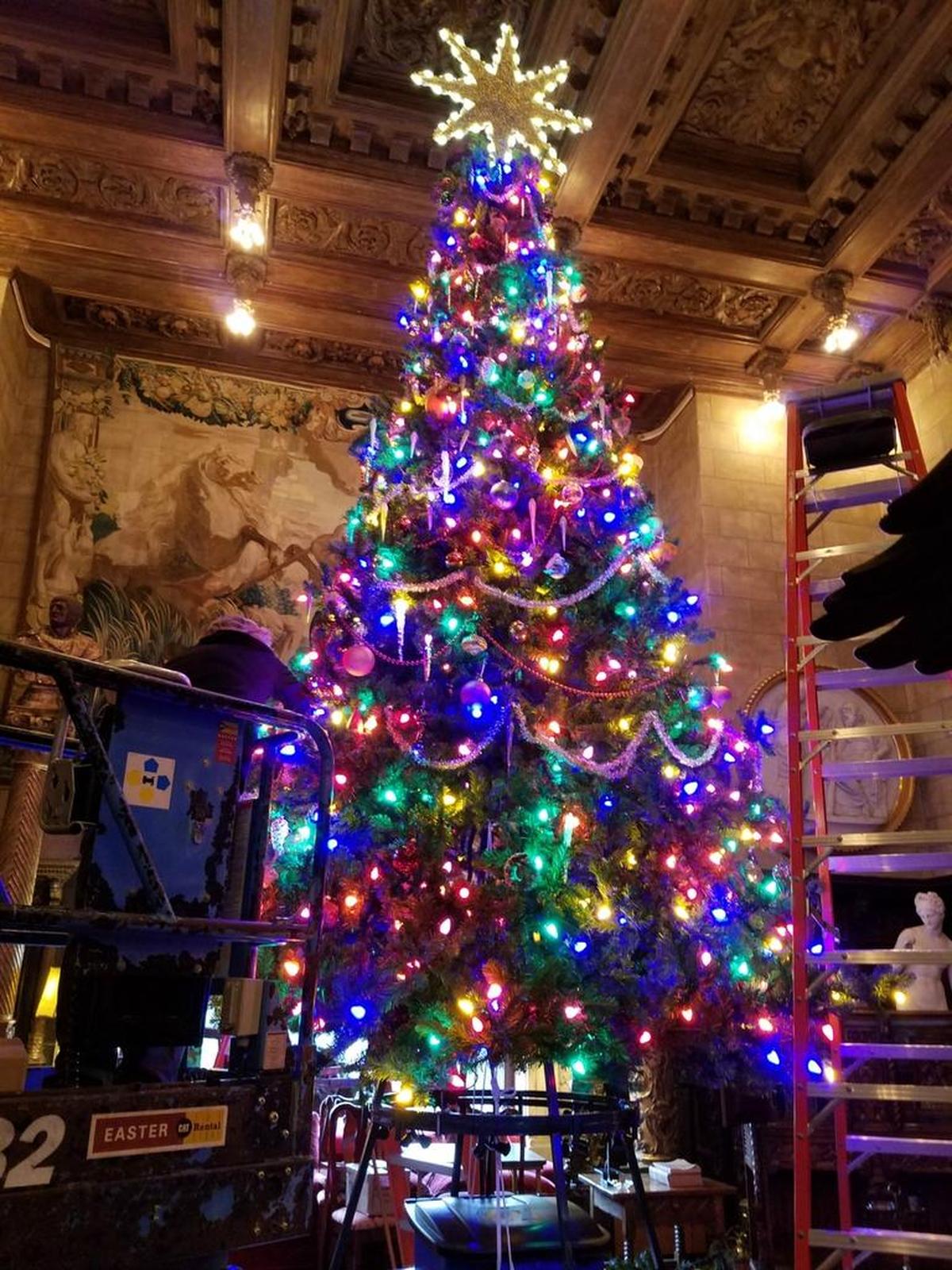 Karen Garton, on the lift, helps prepare Hearst Castle for the Christmas season.