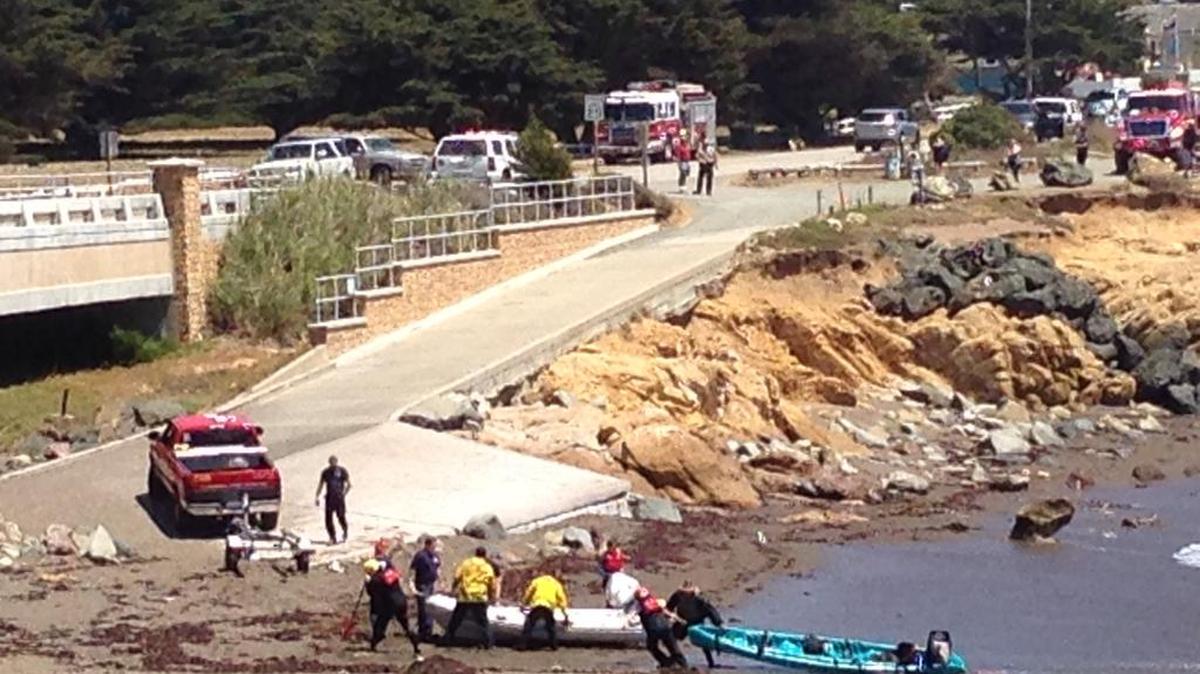 Ocean rescue personnel bring in a kayak that flipped over while carrying a Cambria man and his 12-year-old son off Leffingwell Landing.