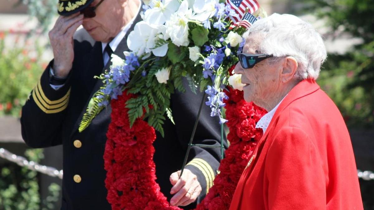 Walt and Doris Stacy place the memorial wreath in front of the Cambria Veterans Memorial on Monday.