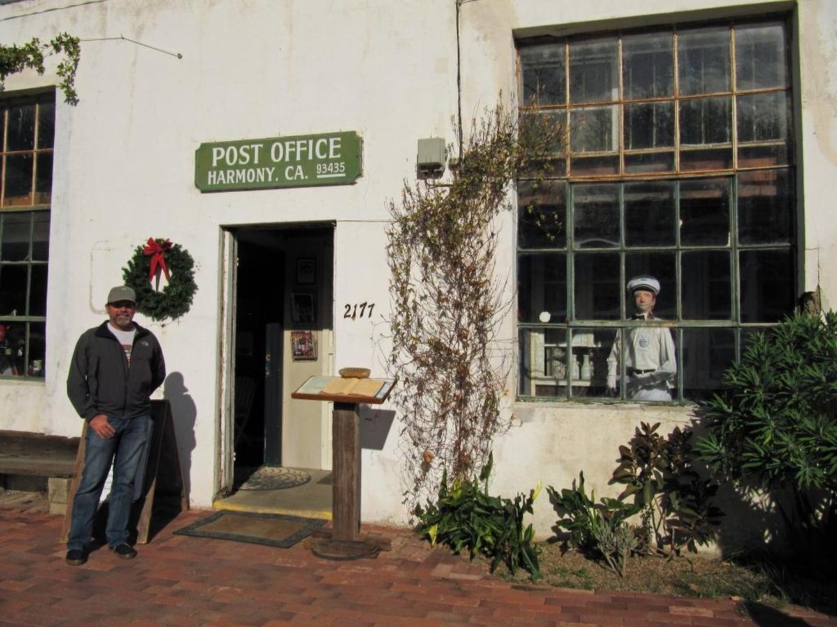 Tom Halen stands outside the Harmony Post Office in the Harmony Valley Creamery building, the most visible structure in the town’s block-long “downtown” strip.