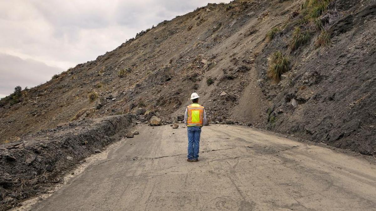 Bret Haney, construction inspector with Caltrans, looks at the south side of the Mud Creek Slide on Highway 1 in May.