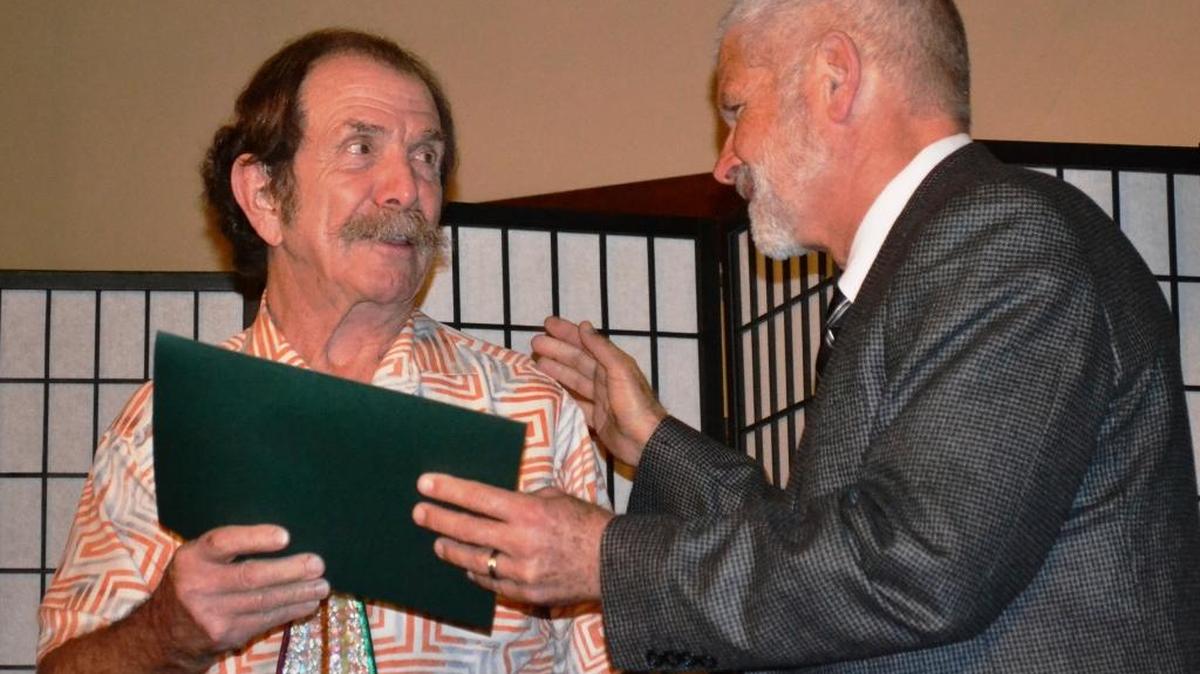 Jay Burbank, Cambria’s 2016 Citizen of the Year, at left, accepts a county proclamation from Supervisor Bruce Gibson at the Cambria Chamber of Commerce board installation dinner Jan. 17.