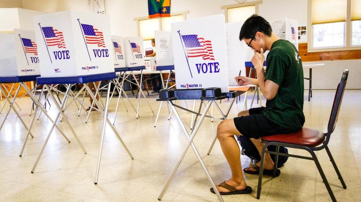 Christopher Chun casts his vote at the polls at the Zion Lutheran Church in San Luis Obispo.