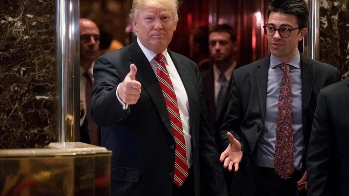 President-elect Donald Trump gives a thumbs up to members of the media after meeting with Martin Luther King III, son of Martin Luther King Jr., at Trump Tower in New York on Jan. 16, 2017.