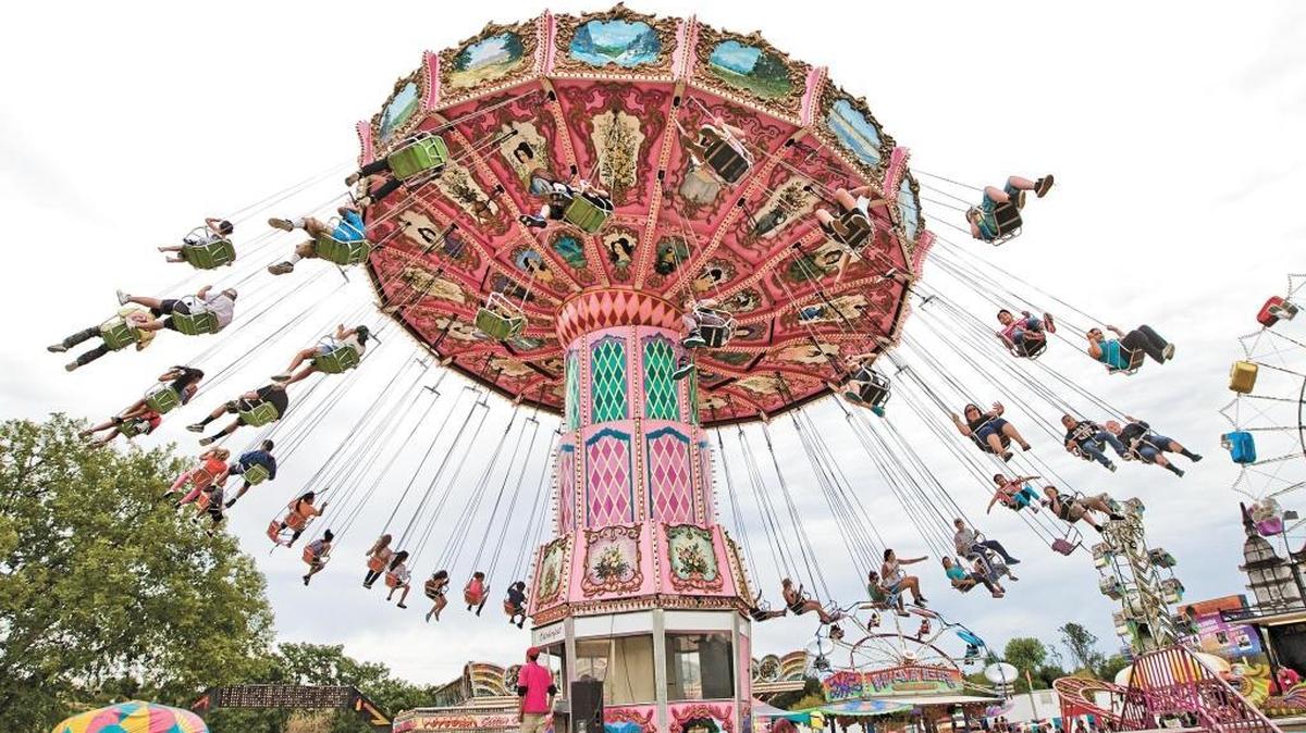 Fair-goers ride the Oktoberfest Wave Swinger ride at the 2014 California Mid-State Fair.