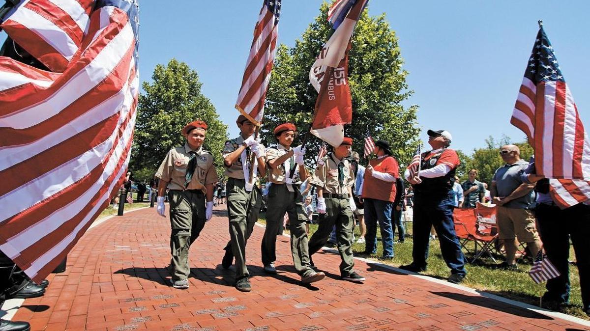 Members of Boy Scout Troop No. 155 present the colors during the 2015 Memorial Day ceremony at the Faces of Freedom Veterans Memorial in Atascadero.