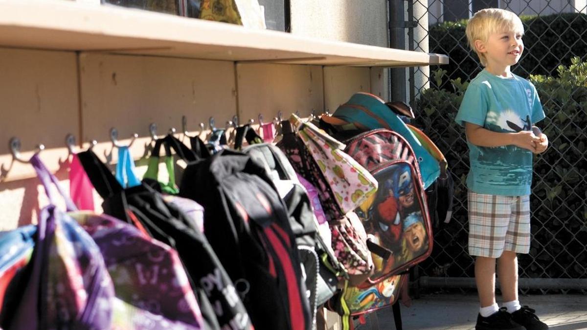 Wyatt Babcock,4, poses for a photo after hanging up his backpack at Santa Margarita Elementary School.
