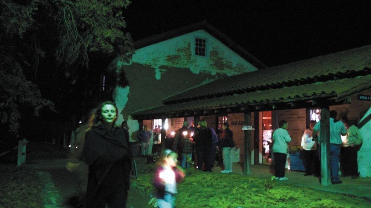 Vickie Carroll of Templeton and her daughter Madeleine, 6, walk near the Rios-Caledonia Adobe in a eery light during ‘A Candlelight Tour of the Old Adobe’ in 2005.