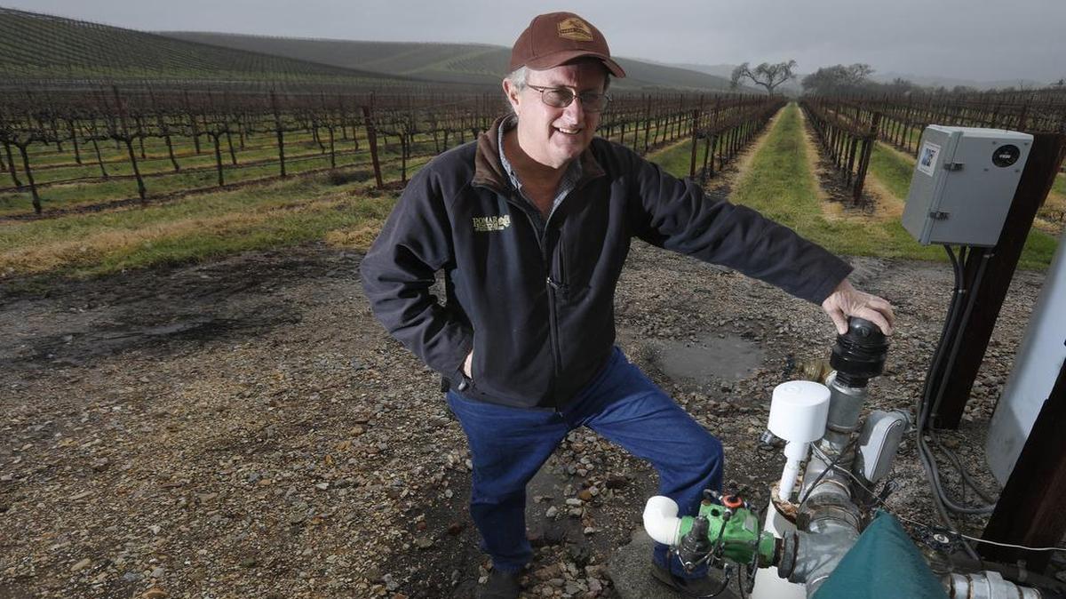Dana Merrill, standing next to one of the wells that irrigates his property, owns Pomar Junction Vineyard & Winery and is helping to form the Estrella-El Pomar-Creston water district in the North County.