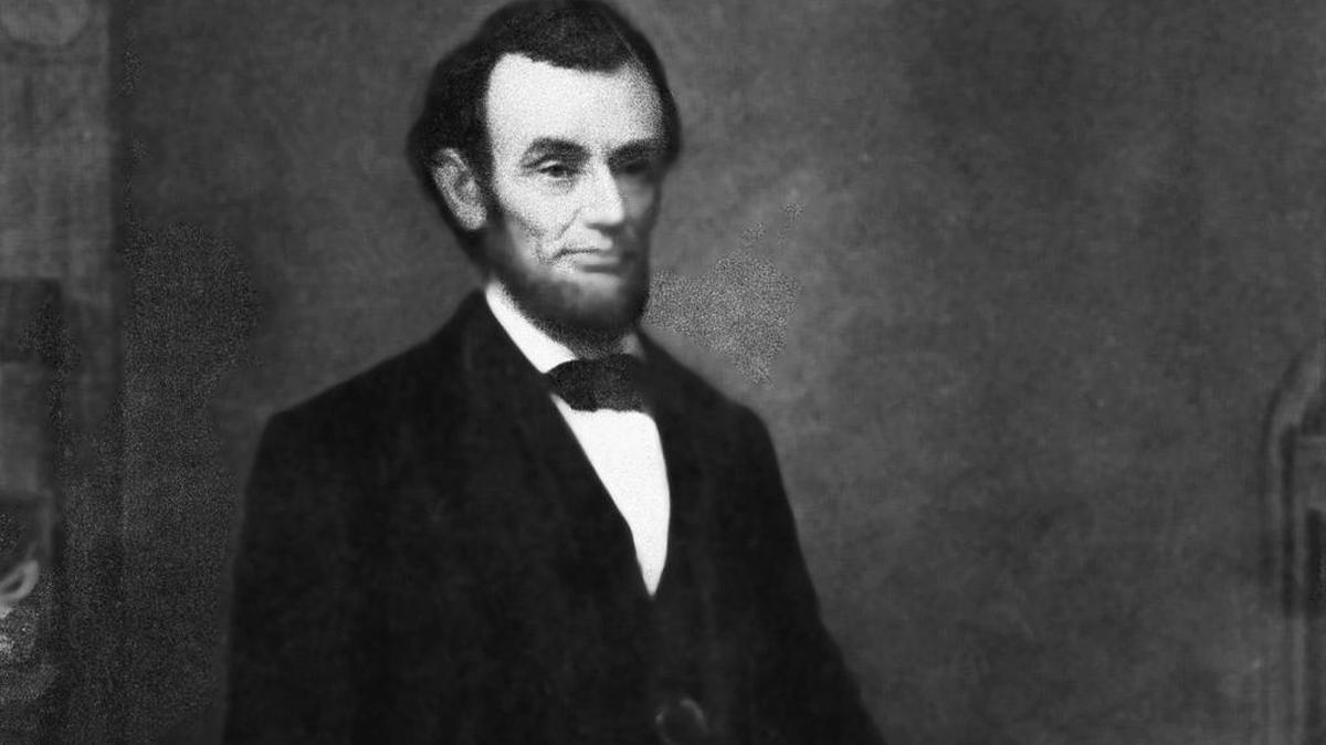 President Abraham Lincoln is shown in a formal portrait, holding the 13th Amendment of the Constitution.