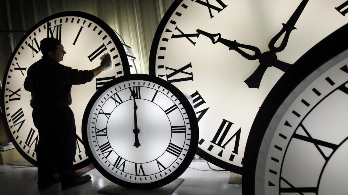 Electric Time Co. employee Walter Rodriguez cleans the face of an 84-inch Wegman clock at the plant in Medfield, Mass., in October 2008.
