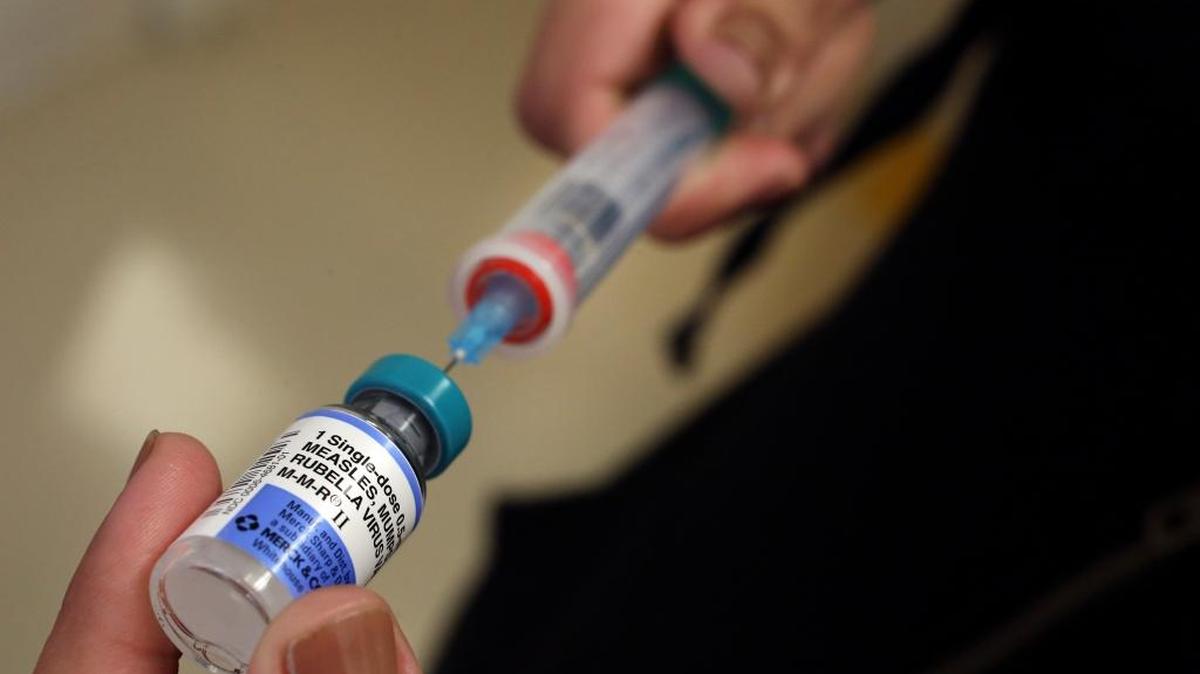 A vial containing the MMR vaccine is loaded into a syringe before being given to a 1-year-old baby at the Medical Arts Pediatric Med Group in Los Angeles on Feb. 6, 2015.
