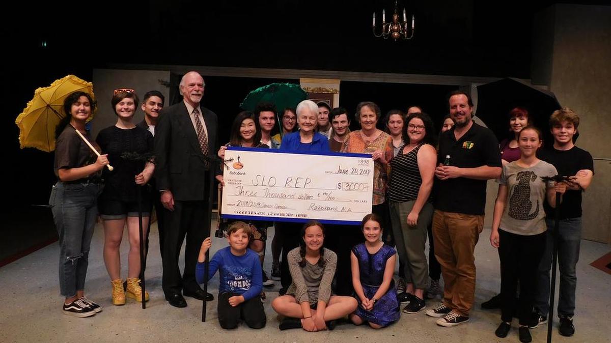 The cast of SLO Repertory Theatre’s Academy of Creative Theatre’s (ACT) summer musical production “Mary Poppins, Jr.” with, from left, Rabobank’s Steve Harding and Lisa Adams, SLO REP Board Member Wilda Rosene, Rabobank’s Kandy Noël and SLO REP’s Kerry DiMaggio and Kevin Harris, accepts a check in the amount of $3,000 to support of the theatre’s ACT educational programs.