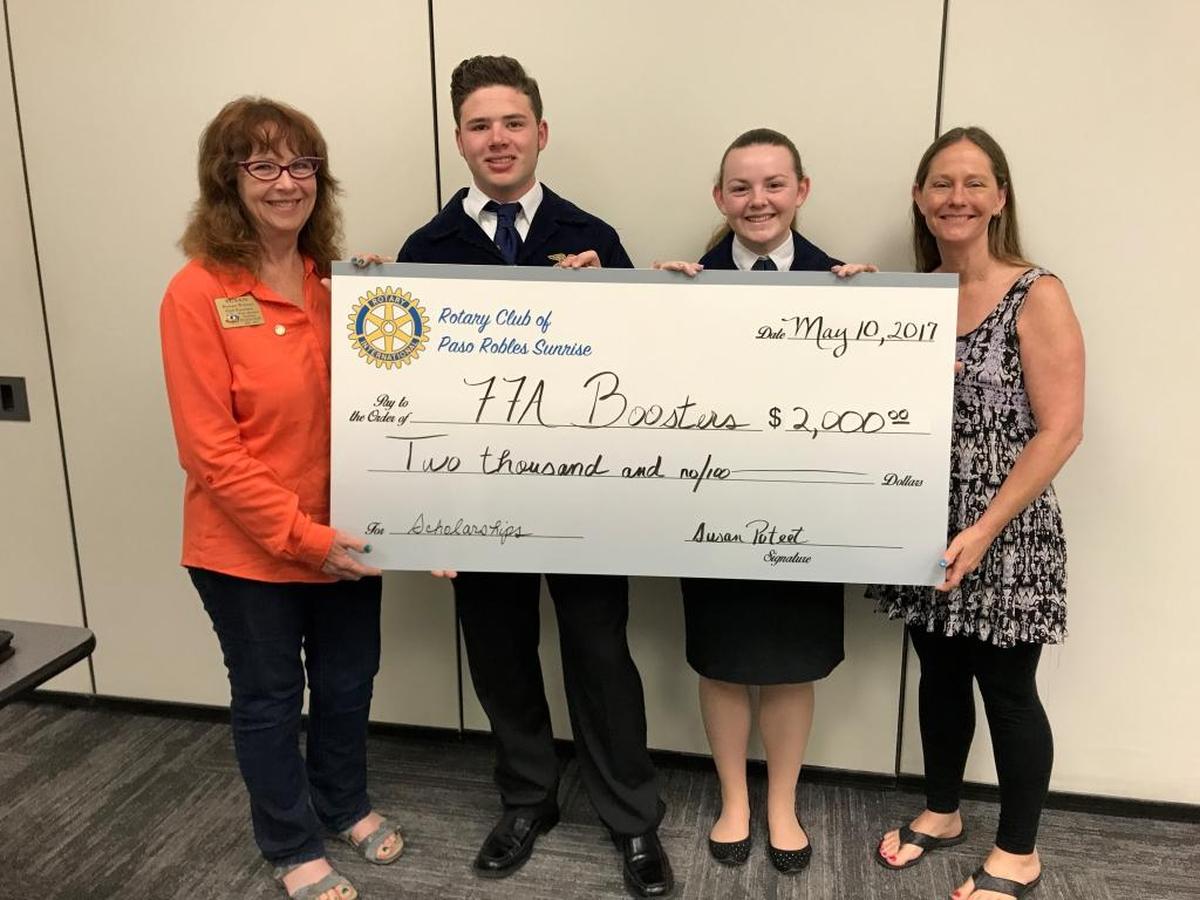 Susan Branche-Poteet, left, and Kay McLain, right, present a $2,000 donation from the Rotary Club of Paso Robles Sunrise to the Paso Robles FFA Booster Club scholarship fund. Accepting the ceremonial check are FFA students Zac Alves and Rebecca McKibbin.