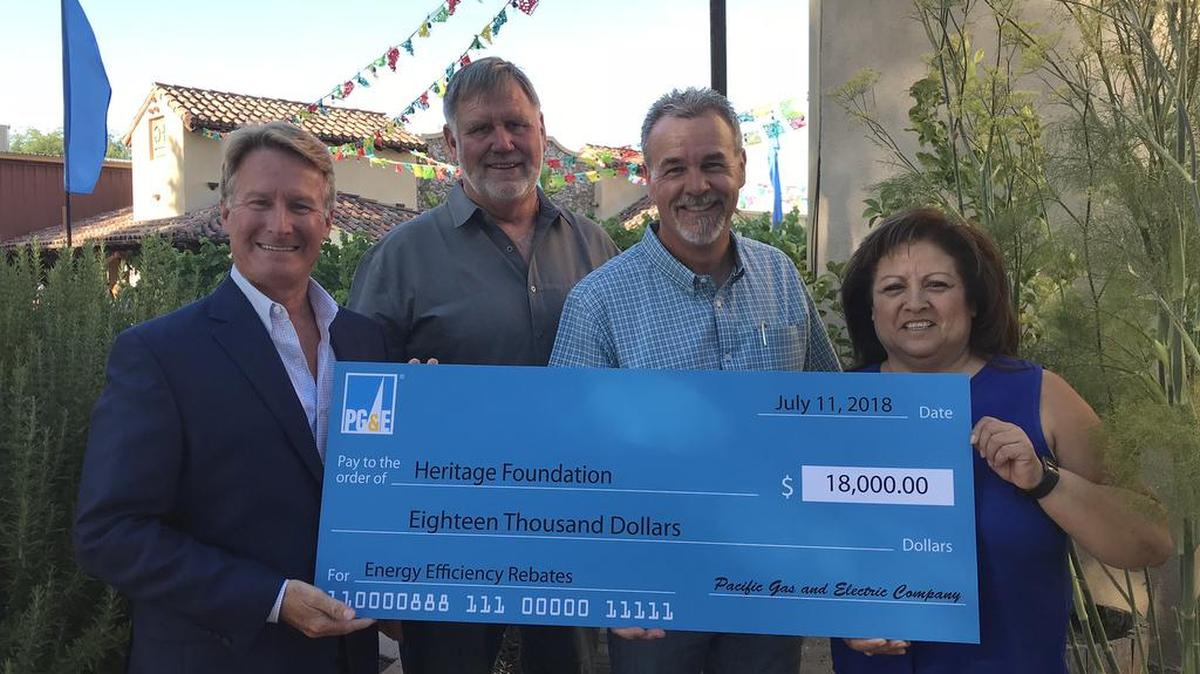 Presenting the $18,000 rebate check to the California Mid-State Fair Heritage Foundation were Eric Daniels and Perla De Leon, both from PG&E. Receiving the check were Chris Darway, California MidState Fair Board President, and Dave Belmont, Heritage Foundation Chairman.