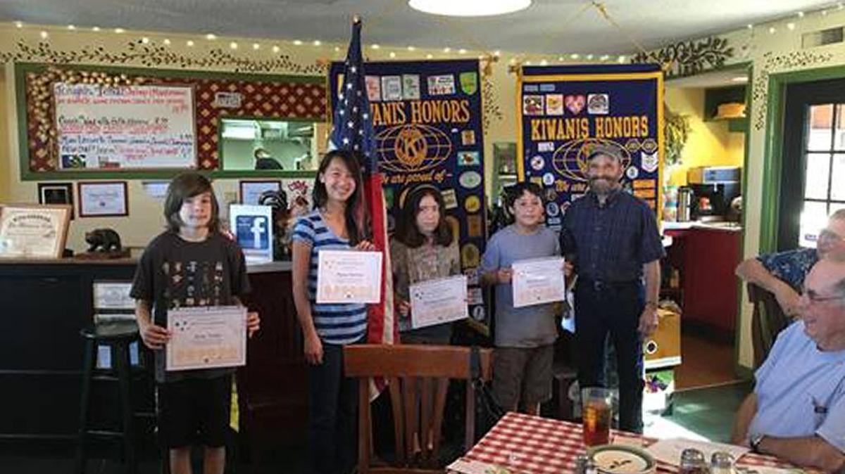 The Bay-Osos Kiwanis Club awarded Jesse Velte, left, Maia Burton, Marina Fonturbel and Henry Salgado of Los Osos Middle School with gift certificates to local restaurants for being outstanding examples of caring. At right, Steve Auslender, youth services committee chair, presented the certificates.