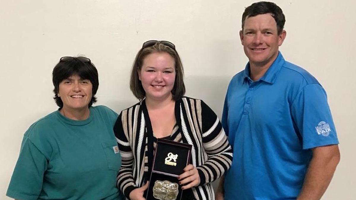 Debra Paver, Templeton 4-H beef leader, left, and Claude Loftus, president of the San Luis Obispo Cattlemen’s Association, right, present the top award in the market steer carcass class to Mallory Seifert from Templeton 4-H.