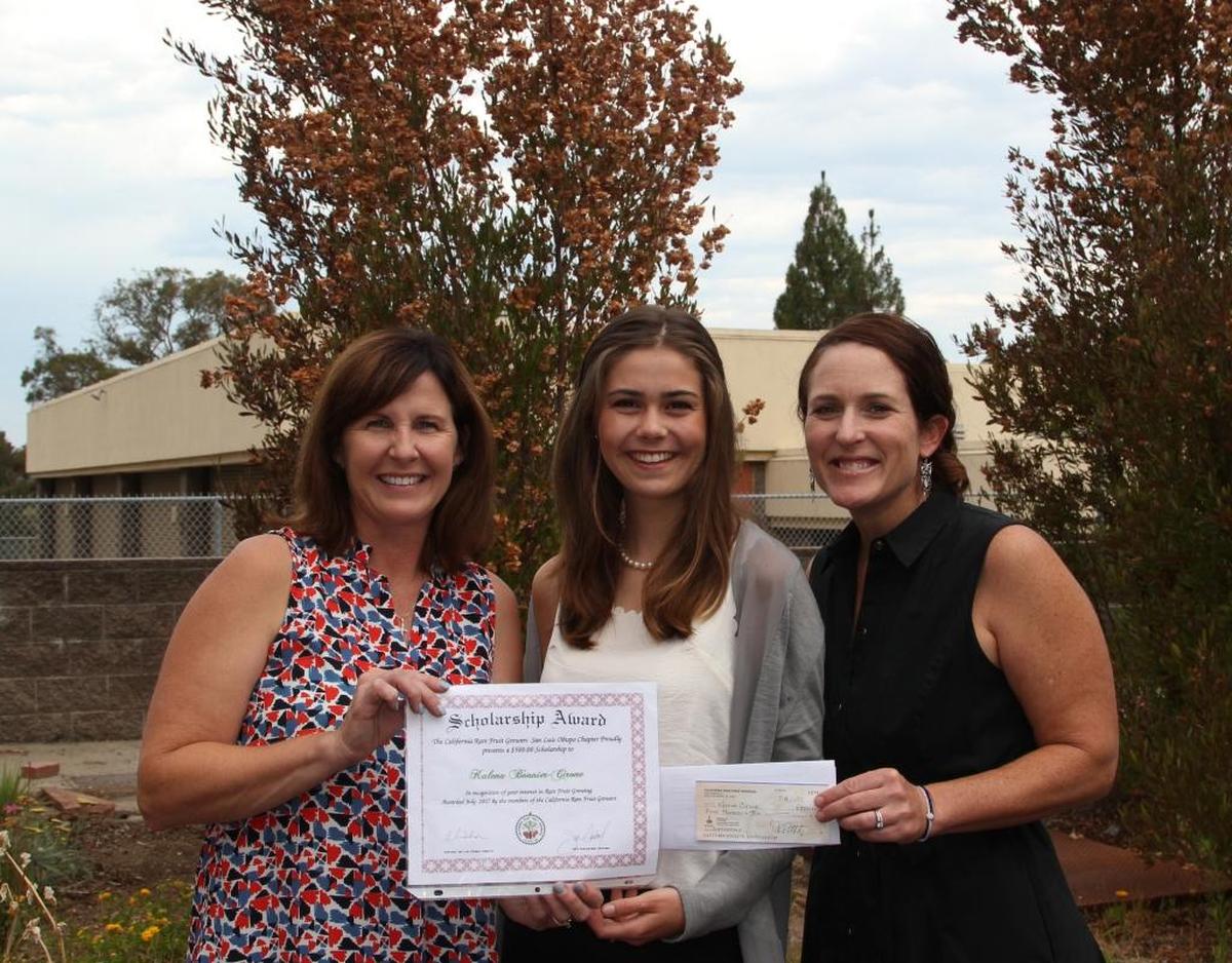 San Luis Obispo High School agriculture teachers Jodi Evans, left, and Anna Bates, right, present the Central Coast Chapter of the California Rare Fruit Growers scholarship to senior Kalena Bonnier-Cirone.