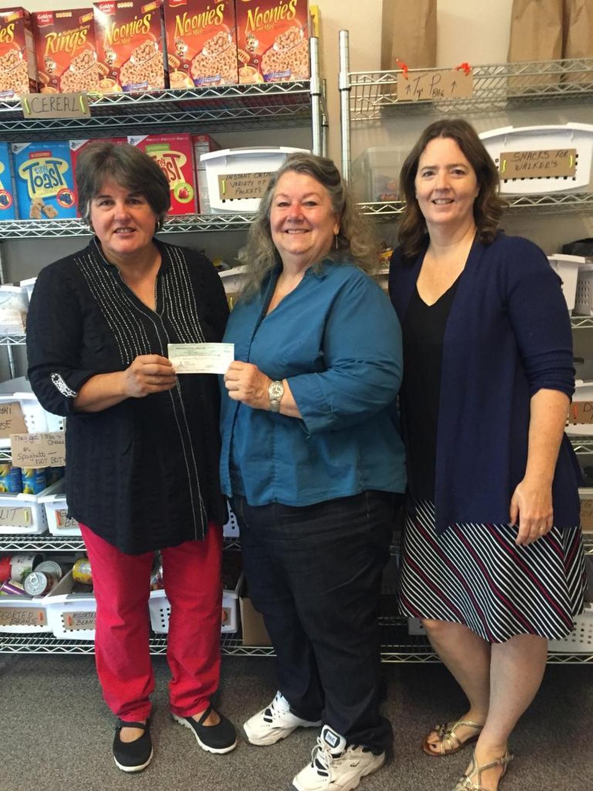 Marlene Jeung, left, receives a check from Connie Rose of the Five Cities Leo Club, center. Also pictured is Angela Dalebout from the Five Cities Christian Women’s Emergency Food Pantry.