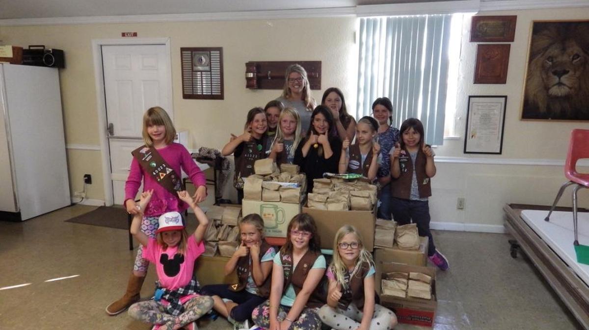 Girl Scout Troop No.40023 recently packaged over 300 snack packs for homeless children. The scouts used a portion of their cookie sale proceeds to purchase juice boxes, granola bars, fruit gummi packs, and an extra snack such as pretzels and cheese. The snack packs, along with a handwritten note for each child, were given to the 5 Cities Homeless Coalition to distribute in the South County.