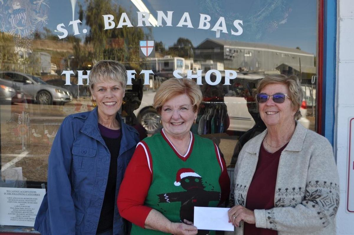 Saint Barnabas Thrift Shop volunteers Pam DeTilla, left, and Mary Ann Hjalmarson, right, present a check in the amount of $1,000 to Chaplin Judy Boen of Captive Hearts. Each month the thrift shop gives a percentage of its income to a nonprofit charitable organization in our community.