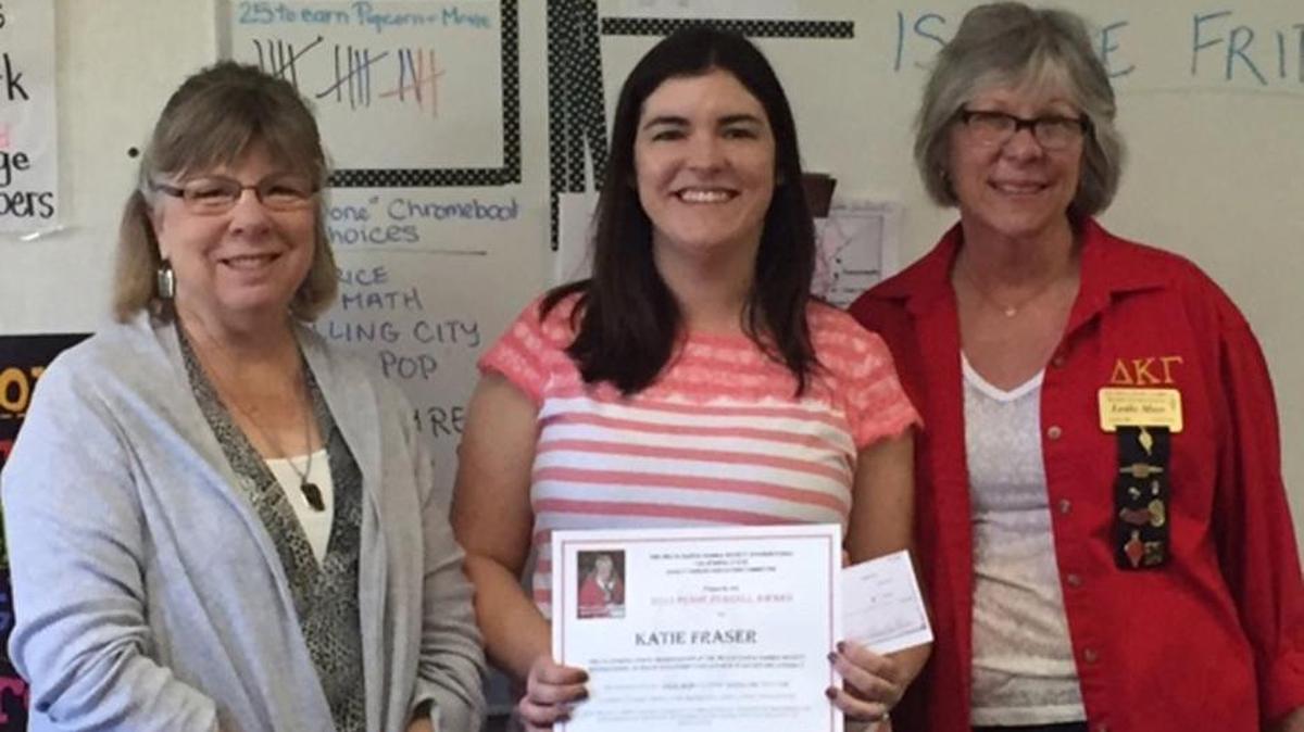 Janis Bailey, left, and Leslie Moss, right, of the Alpha Mu Chapter of Delta Kappa Gamma International present Templeton Elementary School teacher Katie Fraser, center, with an educational grant for her classroom library.