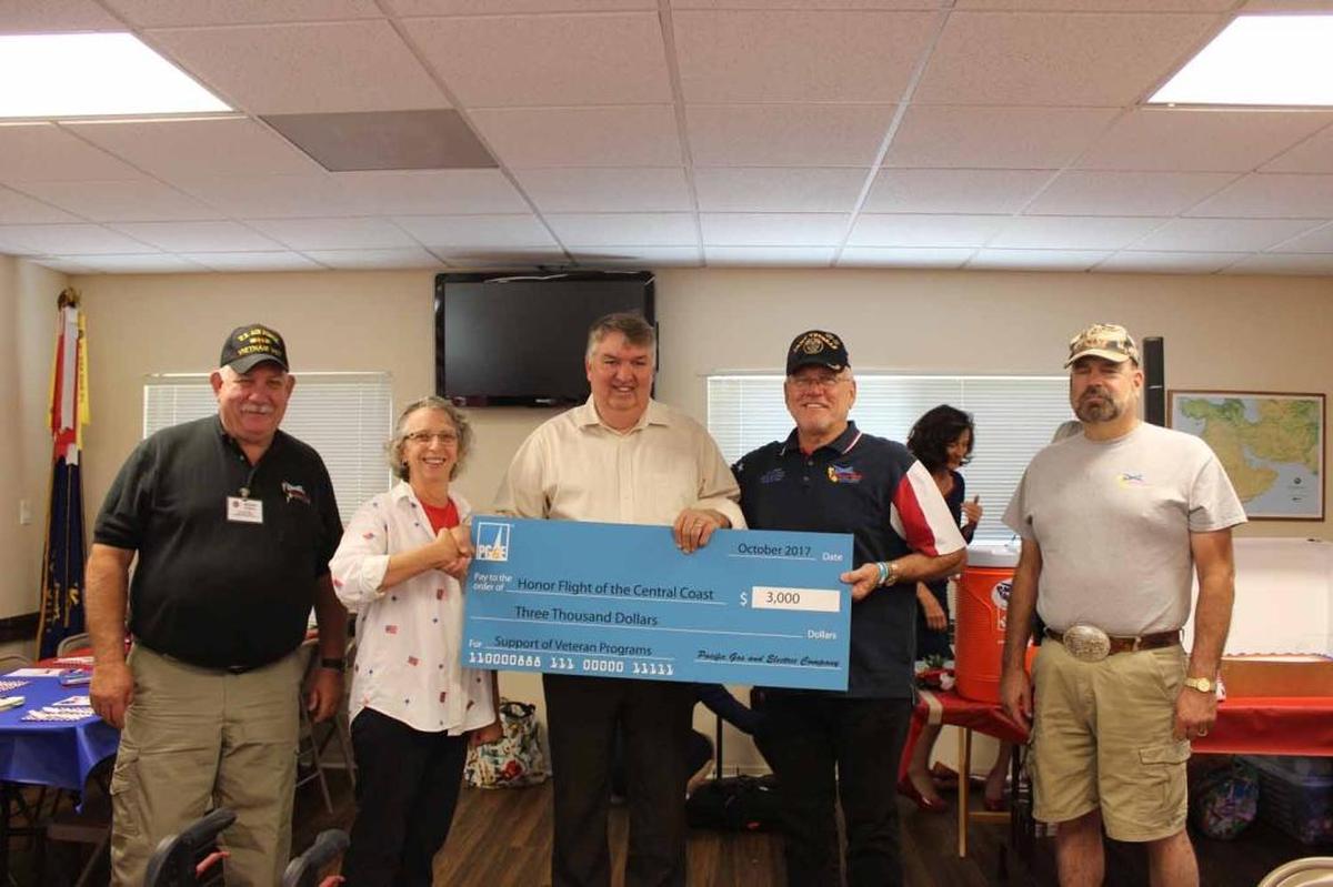 John Lindsay, PG&E meteorologist, center, presents the donation check to Honor Flight of the Central Coast board members, from left, Rich Power, Janice House, Jay Conner and Robert Tolan.
