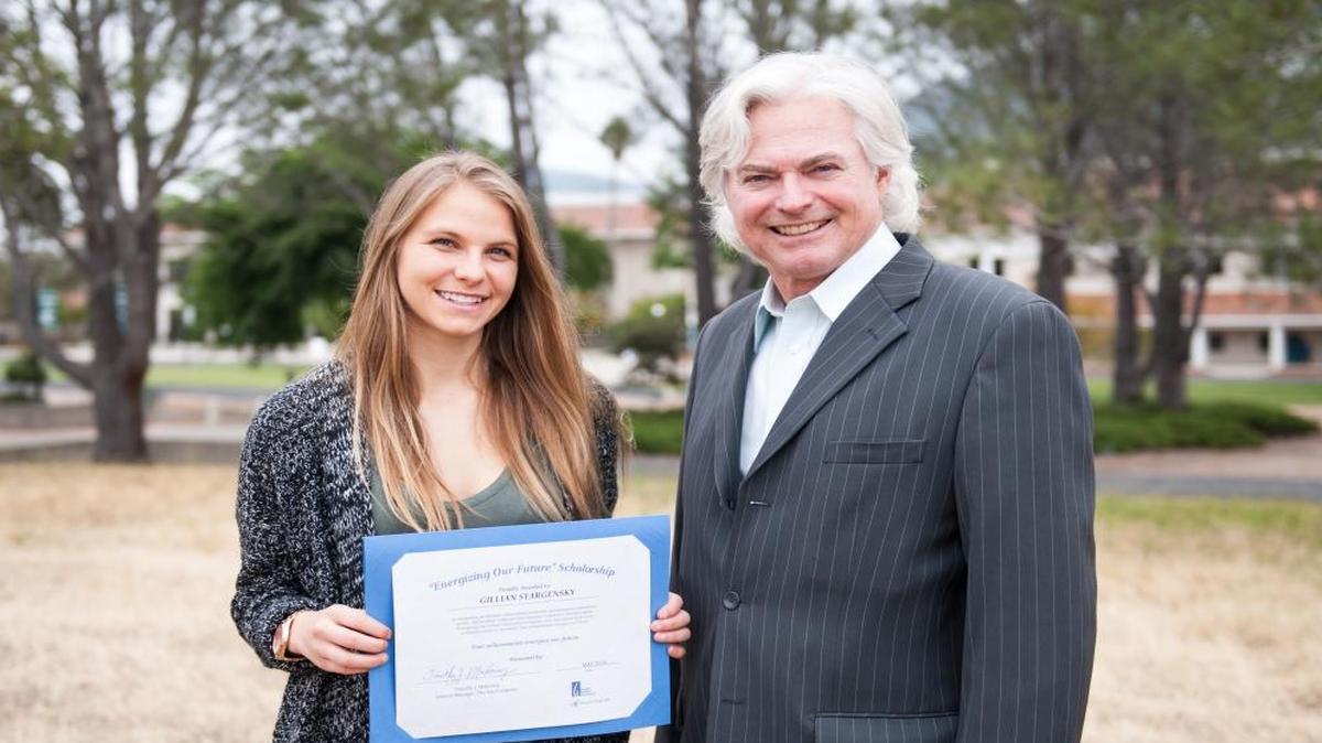 Cuesta College engineering student Gillian Stargensk receives a scholarship from Timothy Mahoney, Southern California Gas Co. district manager, for her commitment to studying engineering.