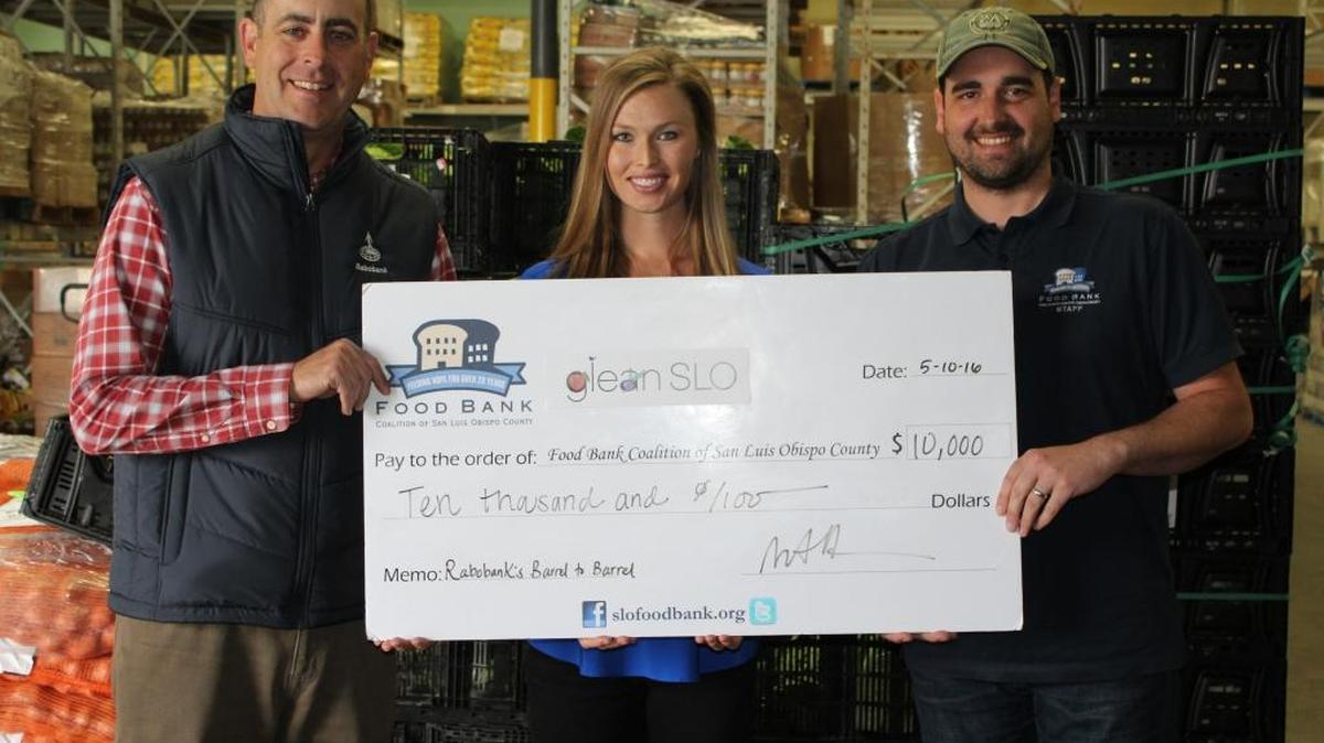 Rabobank recently presented $10,000 to GleanSLO, a program of the Food Bank Coalition of San Luis Obispo County, for its title sponsorship of Wine, Waves & Beyond’s Barrel to Barrel event recently held in Pismo Beach. From left, Matt Allen and Jeannette McClure of Rabobank present the donation to Tim Parker of the food bank.
