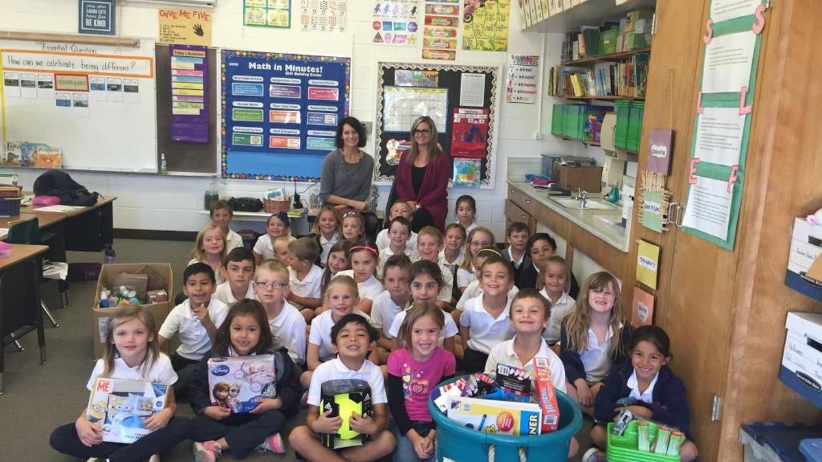 First-grade students at St. Patrick School display items they brought to donate to a program that supports local youth living with mental illness. With the class at left in the back is Jill Bolster-White, executive director of Transitions-Mental Health Association, and teacher Monica Reichmuth, right.