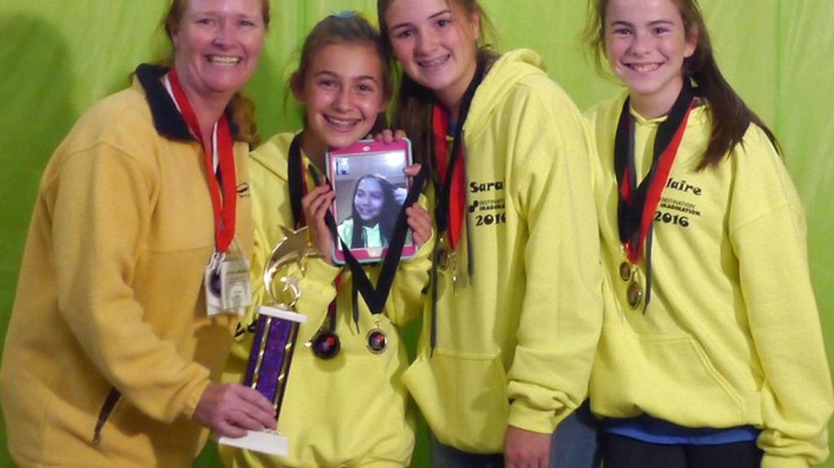 Team Bananas is headed to the Destination Imagination Global Finals to compete at the international academic competition in Knoxville, Tenn. Team manager Karen Beaudin, left, Lorena Carroll with an image of team member Felisa Racinez on her iPad, Sarah Beaudin and Claire Devaney at the state competition where they took top honors.
