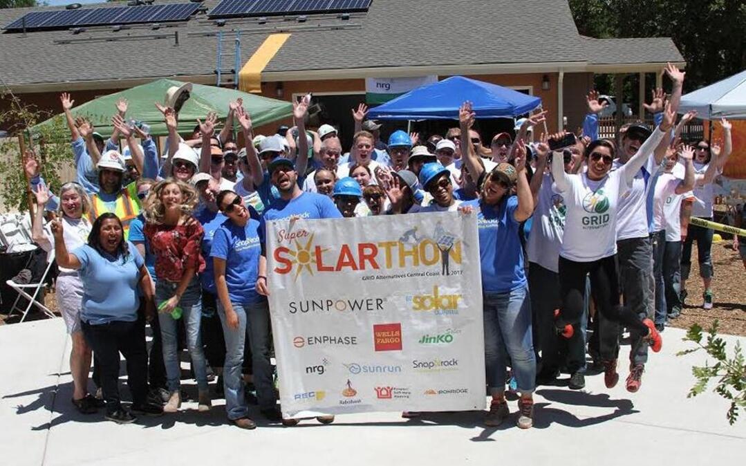 Volunteers gathered for a group photo at the Solarthon solar panel installation neighborhood block party.